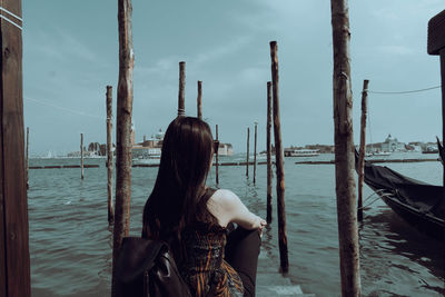 Rear view of woman looking at sea against sky