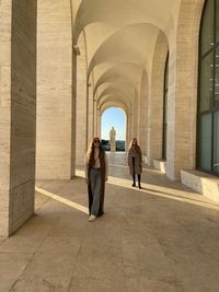 People walking in corridor of building