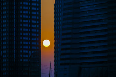 Low angle view of illuminated building against sky at dusk