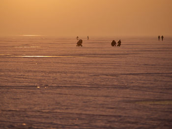 Scenic view of sea against clear sky at sunset