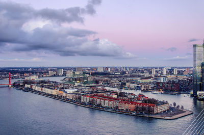 Aerial view of the river nieuwe maas with noordereiland neighbourhood under a coloured sky 