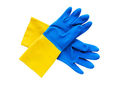 Close-up of yellow hand over blue background