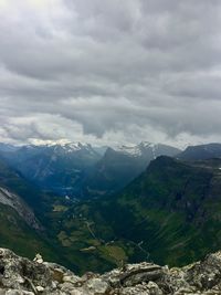 Scenic view of valley and mountains against sky
