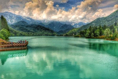 Scenic view of lake and mountains against sky