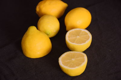 Close-up of oranges on table against black background