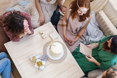 High angle view of people sitting on sofa