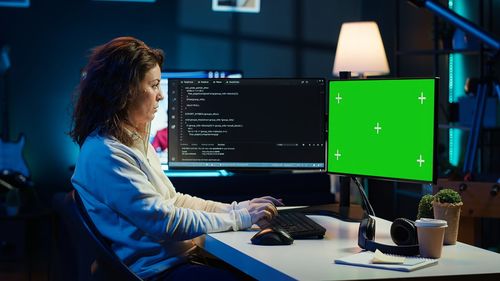 Rear view of woman using computer