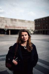 Portrait of beautiful young woman standing in winter