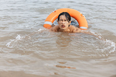 Portrait of woman swimming in lake