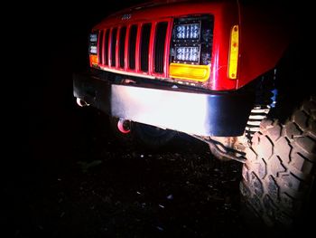 Close-up of illuminated red car at night