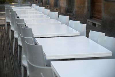 Empty chairs and tables in building