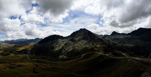 Scenic view of mountains against cloudy sky