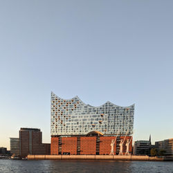 Buildings in city against clear sky