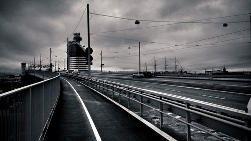 Railroad track against cloudy sky