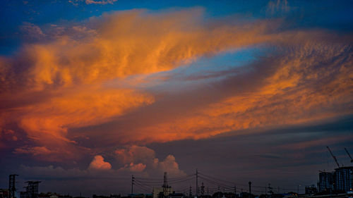 Low angle view of dramatic sky during sunrise