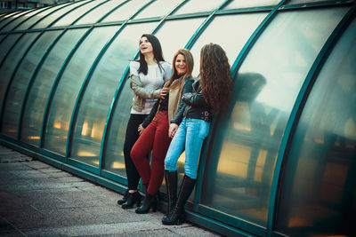 Female friends standing on street in city