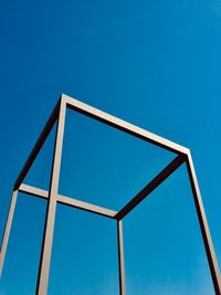 Low angle view of metal structure against clear blue sky