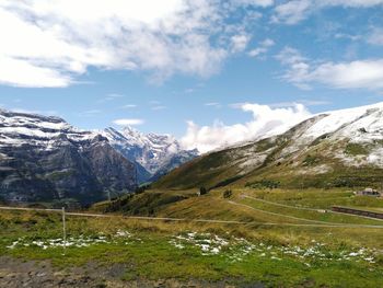 Scenic view of mountains against cloudy sky