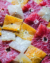 Flatlay of winter citrus fruit cut to rectangular slices.