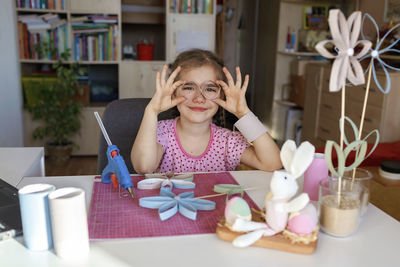 Portrait of cute girl doing craft at home
