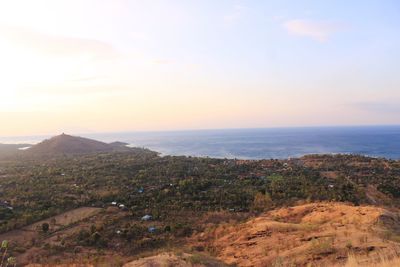 Scenic view of sea and mountains against sky