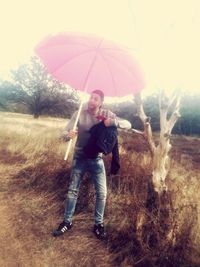 Full length portrait of man standing in rain