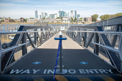 Bridge over river against buildings in city