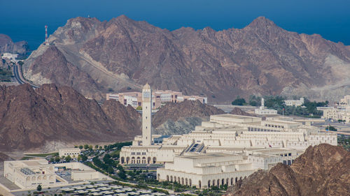 Buildings in city against mountain range