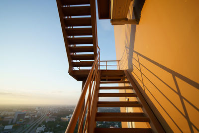 Low angle view of staircase against sky during sunset