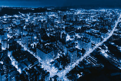 High angle view of illuminated buildings in city at night