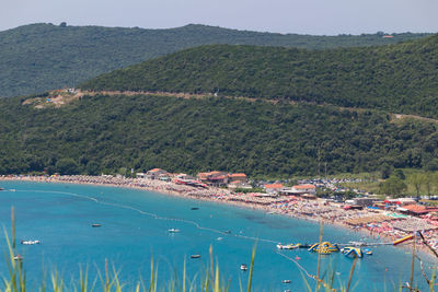 Scenic view of sea and mountains against sky