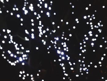 Low angle view of illuminated lights at night