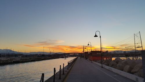 Pier on sea at sunset