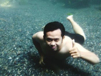 Portrait of smiling man swimming in pool