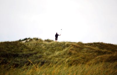 People standing on grassy field