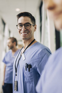 Portrait of happy male healthcare staff wearing eyeglasses at hospital