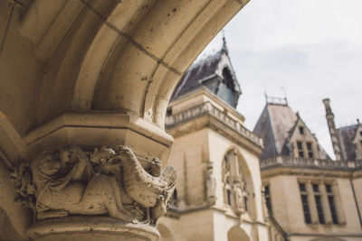 Low angle view of sculpture on historic building