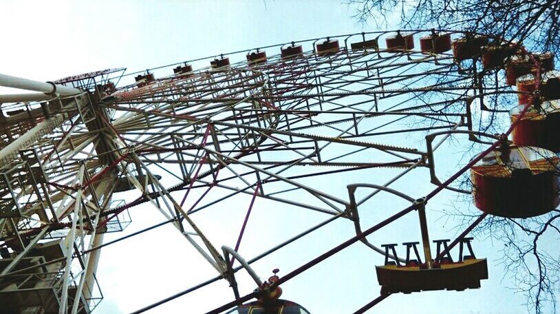 low angle view, amusement park, amusement park ride, arts culture and entertainment, sky, clear sky, ferris wheel, blue, metal, built structure, metallic, architecture, outdoors, day, lighting equipment, no people, fun, technology, enjoyment, chain swing ride