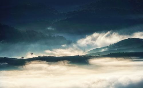 Low angle view of storm clouds over mountain