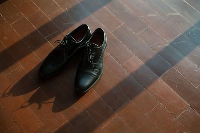 High angle view of black shoes on tiled floor