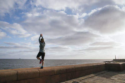 Girl exercising near the sea