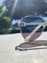 Close-up of sunglasses on glass during sunny day