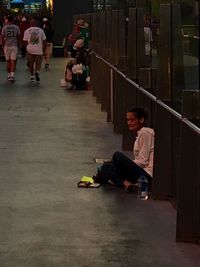 Rear view of woman sitting on bench