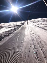 Man skiing on snowcapped mountain against sky