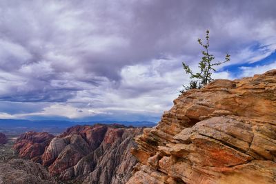 Scenic view of mountains against cloudy sky