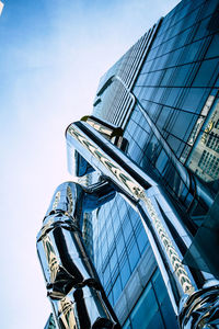 Low angle view of modern building against blue sky