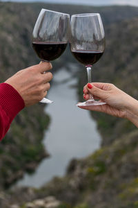 Close-up of hands toasting in the mountains