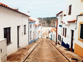 Street amidst buildings in town against sky