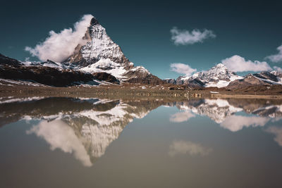 Scenic view of snowcapped mountains against sky