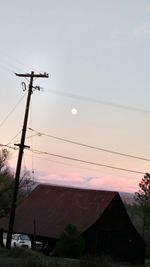 Low angle view of power lines against sky